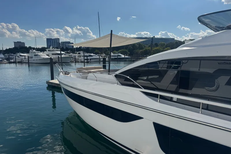 Slide: The Image of 2023 Azimut Fly 68 yacht docked at a marina under a sunny sky. - 180
