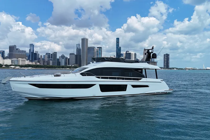 Slide: The Image of 2023 Azimut Fly 68 yacht cruising near city skyline under blue sky. - 6