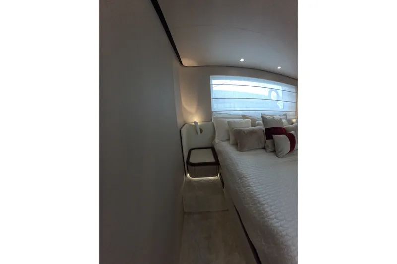 Slide: The Image of Luxurious bedroom interior of 2023 Azimut Fly 68 yacht, featuring elegant bedding and ambient lighting. - 102