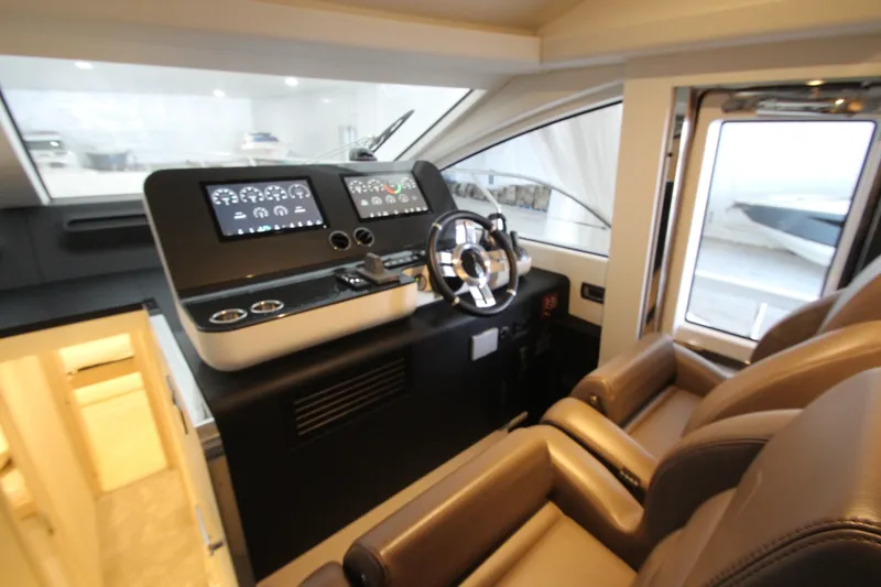 Slide: The Image of Luxurious helm of 2023 Azimut Fly 68 yacht with modern controls and leather seating. - 67