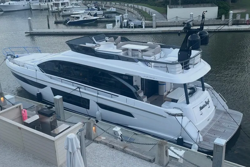 Slide: The Image of 2023 Azimut Fly 68 luxury yacht docked at a marina, showcasing sleek design and spacious deck. - 120