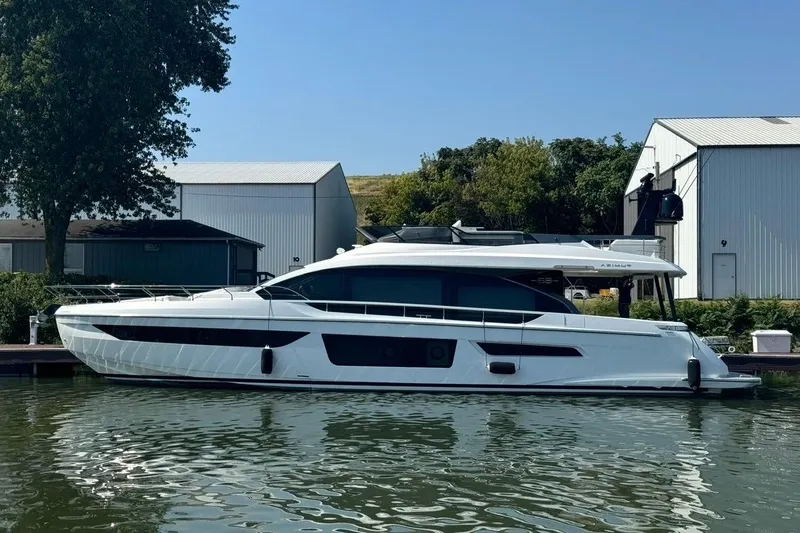 Slide: The Image of 2023 Azimut Fly 68 yacht docked by a marina, showcasing sleek design and modern features. - 115