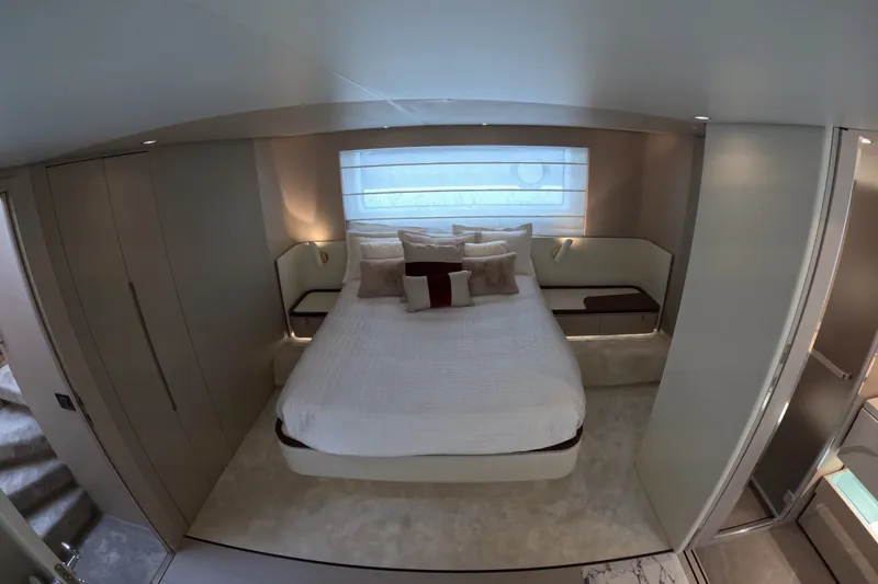 Slide: The Image of Luxurious bedroom interior of 2023 Azimut Fly 68 yacht, featuring elegant design and cozy bedding. - 79