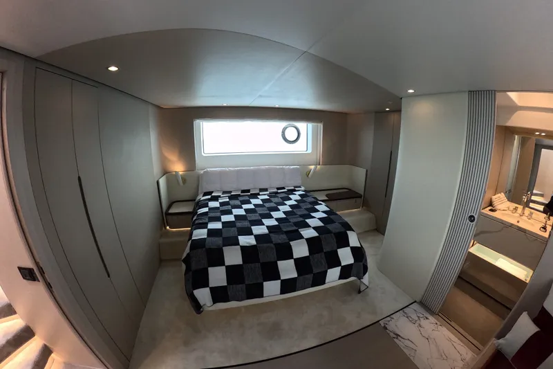 Slide: The Image of Luxurious bedroom interior of 2023 Azimut Fly 68 yacht with modern design and checkered bedding. - 77