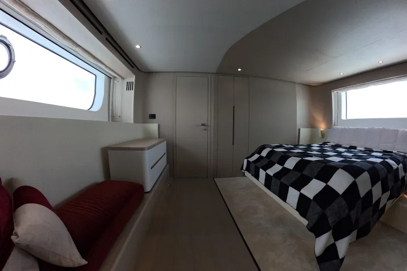 Slide: The Image of Luxurious bedroom interior of 2023 Azimut Fly 68 yacht with modern design and checkered bedding. - 83