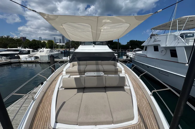 Slide: The Image of Luxurious 2023 Azimut Fly 68 yacht with sunshade and plush seating at marina. - 167