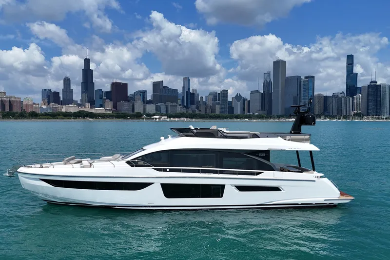 Slide: The Image of 2023 Azimut Fly 68 yacht on water with city skyline backdrop. - 13
