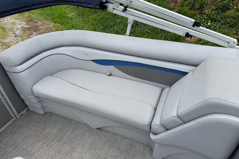 Slide: The Image of 2020 Bennington S 22 SL boat interior with sleek gray seating and blue accent. - 9