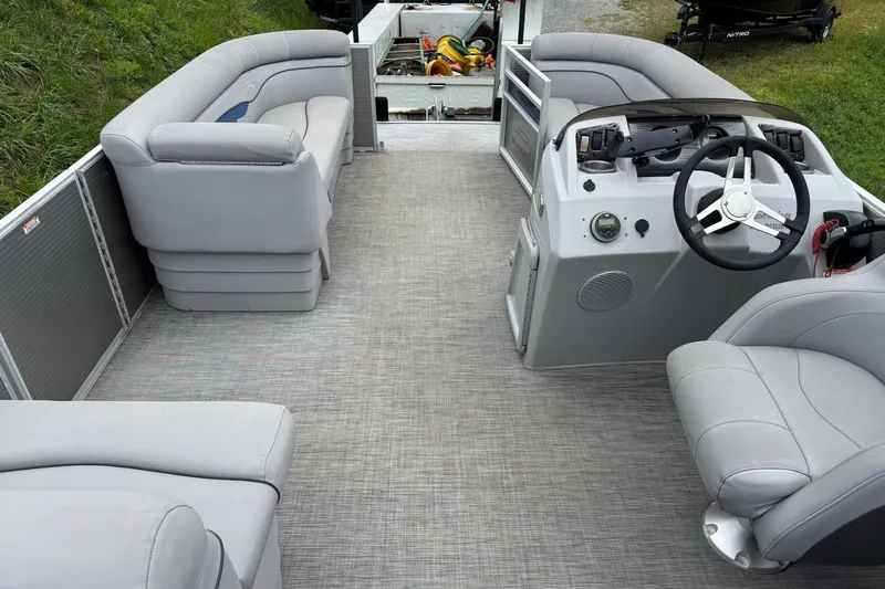Slide: The Image of 2020 Bennington S 22 SL pontoon boat interior with gray seating and steering console. - 14