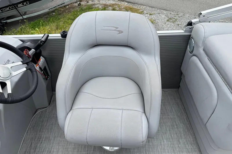 Slide: The Image of Captain's chair in 2020 Bennington S 22 SL pontoon boat, featuring sleek gray upholstery. - 11