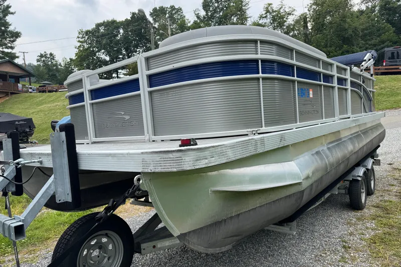 Slide: The Image of 2020 Bennington S 22 SL pontoon boat on trailer, parked outdoors. - 4