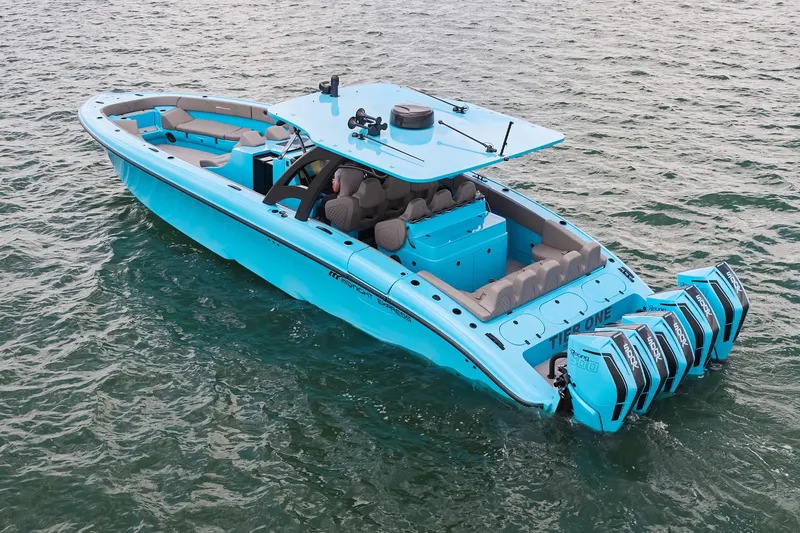 Slide: The Image of Bright blue Midnight Express 43 Open boat with four engines on the water. - 7