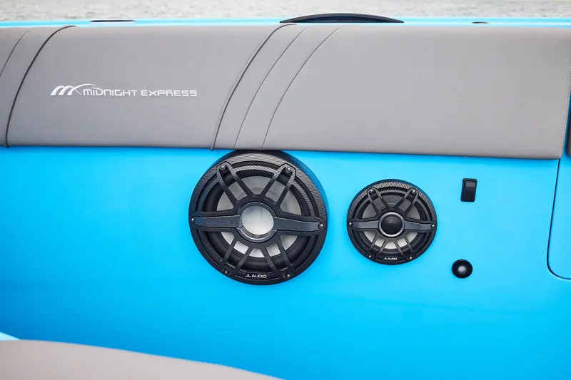 Slide: The Image of Midnight Express 43 Open boat with JL Audio speakers on blue and gray interior. - 13
