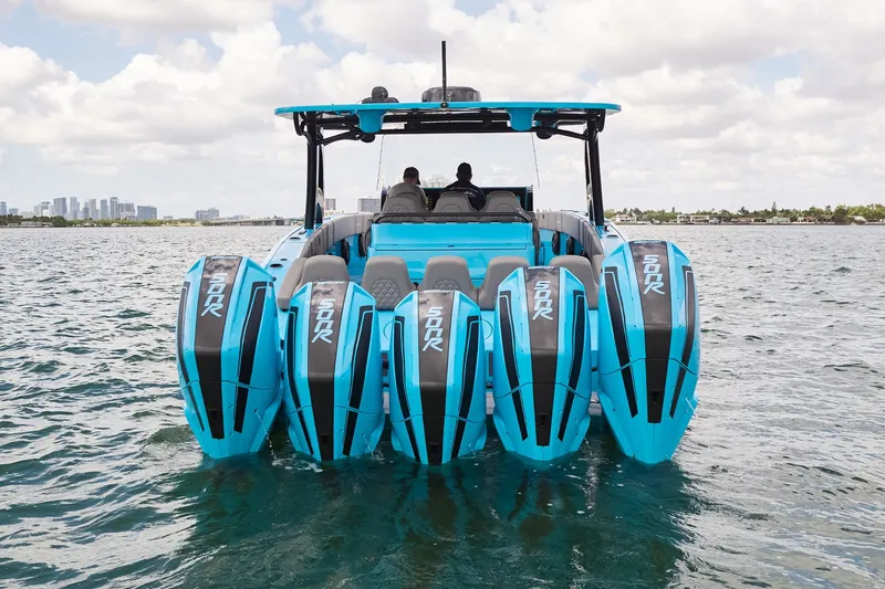 Slide: The Image of Midnight Express 43 Open boat with five blue outboard engines on water. - 8