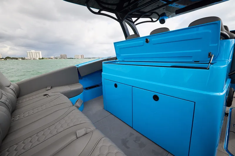 Slide: The Image of Interior view of a Midnight Express 43 Open boat with blue cabinetry and gray seating. - 18