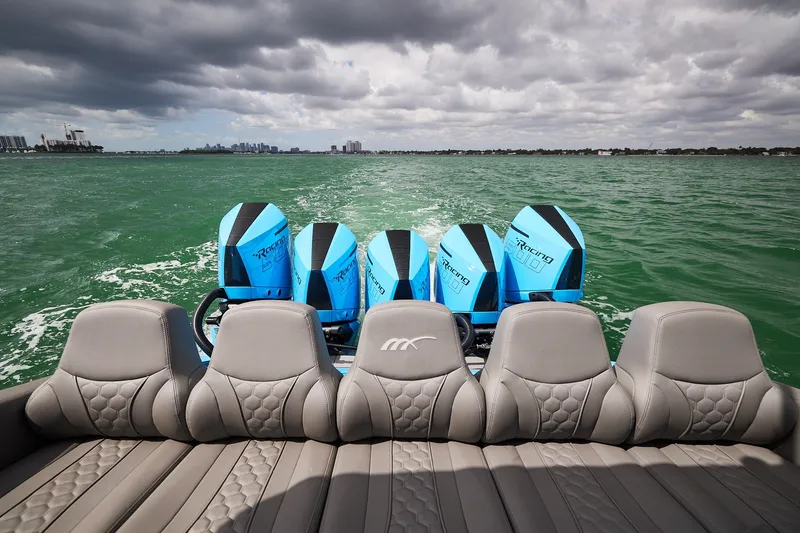 Slide: The Image of Midnight Express 43 Open boat with five powerful outboard engines on green water. - 21