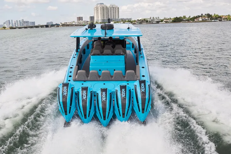Slide: The Image of Blue Midnight Express 43 Open boat with multiple engines cruising on water. - 3