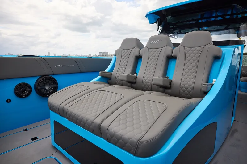 Slide: The Image of Luxurious seating on a Midnight Express 43 Open boat, featuring sleek gray upholstery and modern design. - 10