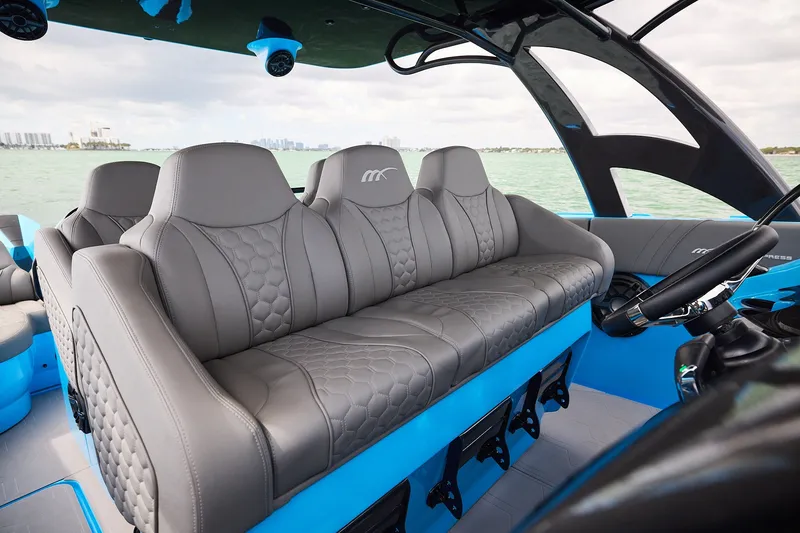 Slide: The Image of Luxury seating on Midnight Express 43 Open boat, featuring sleek gray upholstery and modern design. - 15