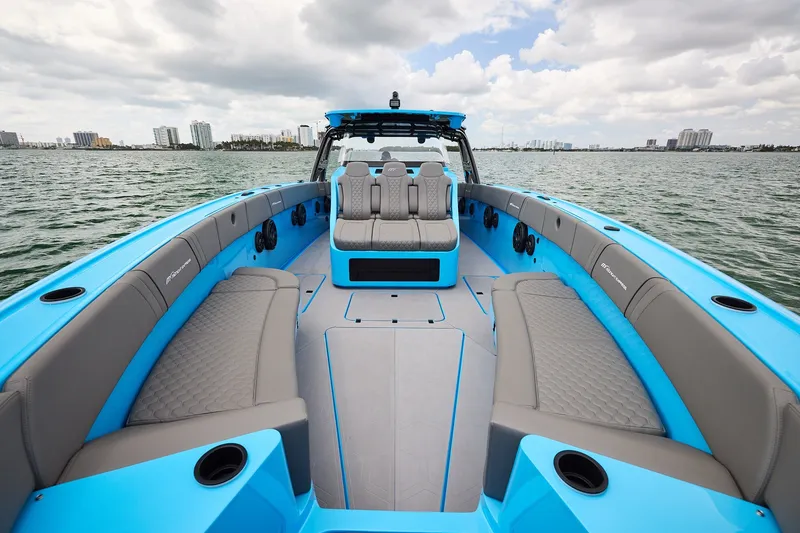 Slide: The Image of Luxurious Midnight Express 43 Open boat interior with blue and gray seating on a calm water backdrop. - 9