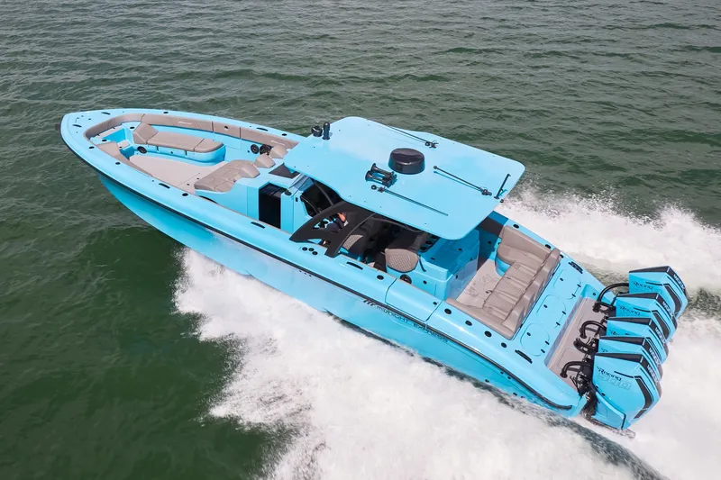 Slide: The Image of Bright blue Midnight Express 43 Open boat speeding on water with multiple engines. - 2