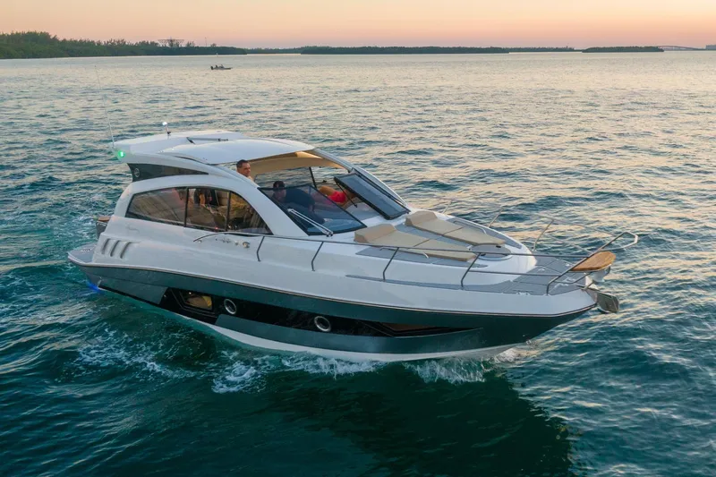 Slide: The Image of 2026 Hanover 375 yacht cruising on serene waters at sunset. - 2