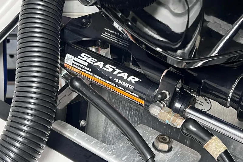 Slide: The Image of Close-up of SeaStar hydraulic steering system in 2024 Tahoe 200 S boat. - 14