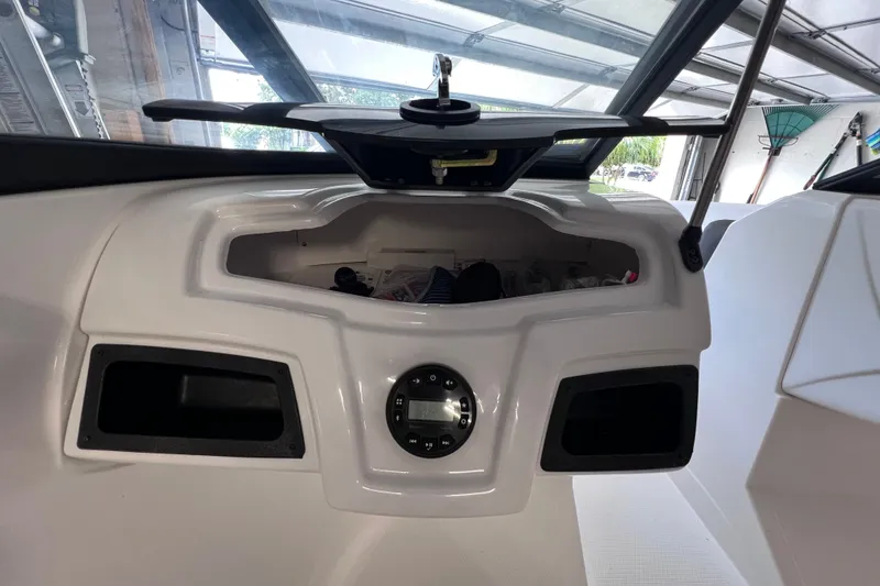 Slide: The Image of Dashboard of 2024 Tahoe 200 S boat with storage compartment and control panel. - 27