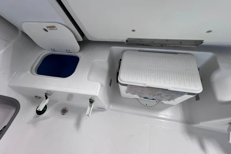 Slide: The Image of 2024 Tahoe 200 S boat interior with storage compartments and cooler. - 35