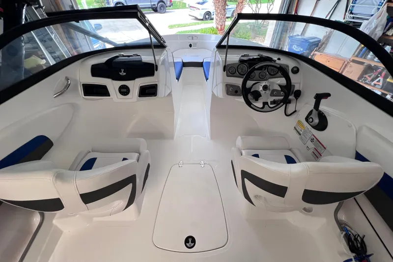 Slide: The Image of 2024 Tahoe 200 S boat interior with steering wheel and seating arrangement. - 23
