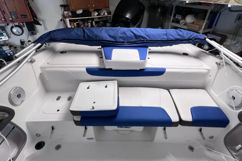 Slide: The Image of 2024 Tahoe 200 S boat interior with blue and white seating and storage compartments. - 16