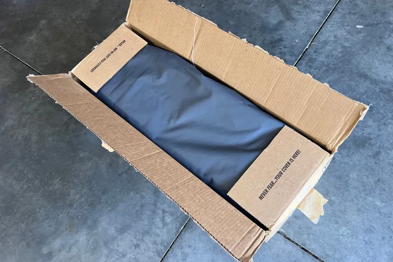 Slide: The Image of Open cardboard box with fabric inside, labeled "Never Fear... Your Cover is Here!" - 38