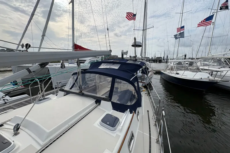 Slide: The Image of Sailboats docked at marina, featuring a 2002 Caliber 40LRC under a cloudy sky. - 5