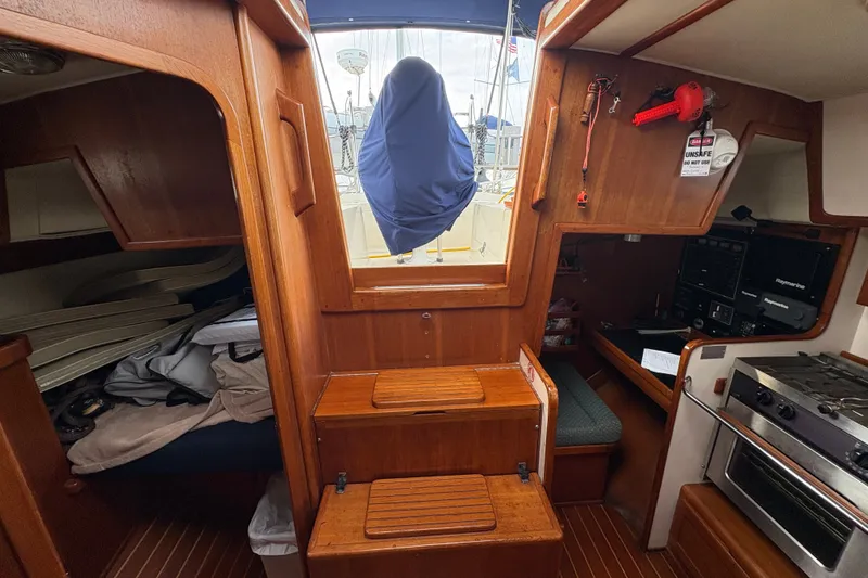 Slide: The Image of Interior of a 2002 Caliber 40LRC sailboat with wood finish and compact kitchen. - 21