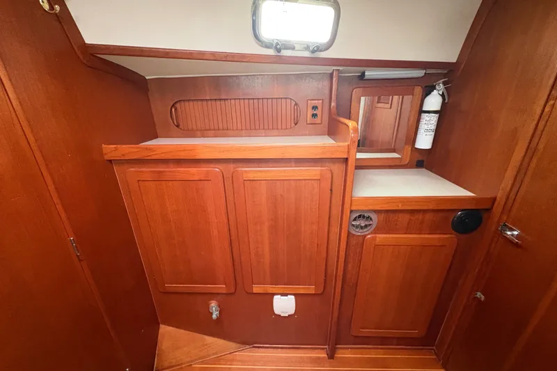 Slide: The Image of Wooden interior of 2002 Caliber 40LRC yacht with cabinets and fire extinguisher. - 22