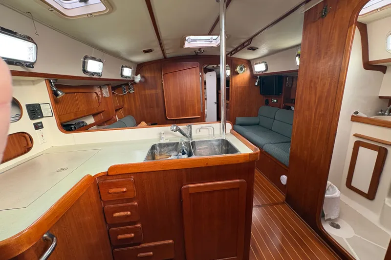 Slide: The Image of Interior of a 2002 Caliber 40LRC sailboat with wood finish and compact kitchen. - 29