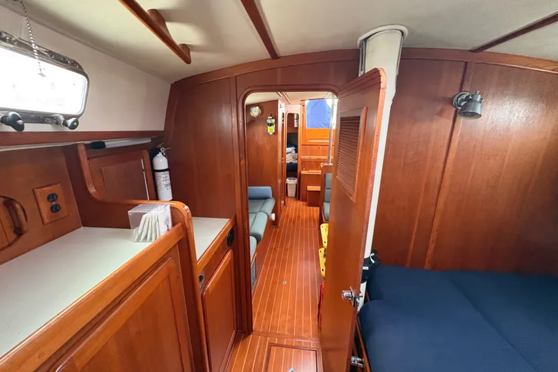 Slide: The Image of Interior of a 2002 Caliber 40LRC sailboat with wooden finishes and cozy cabin layout. - 17