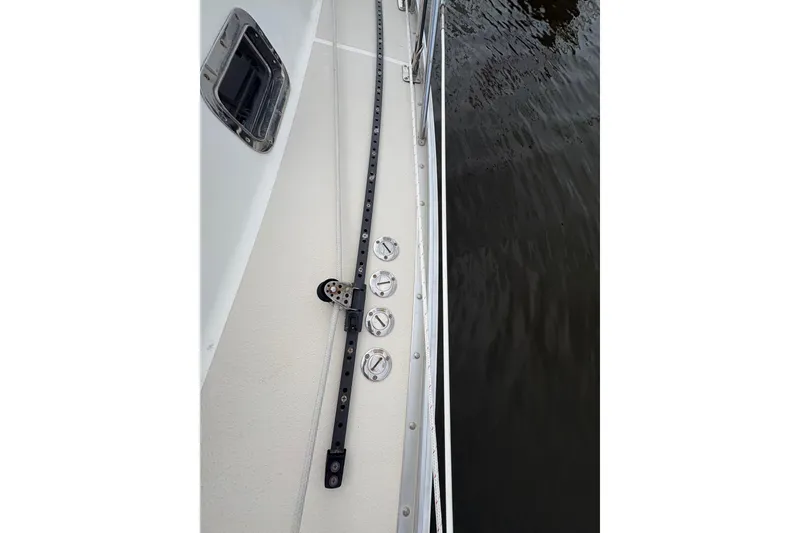 Slide: The Image of Deck view of 2002 Caliber 40LRC sailboat with rigging and water reflection. - 13