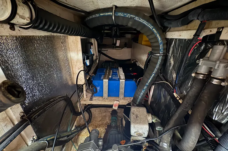 Slide: The Image of Engine compartment of a 2002 Caliber 40LRC sailboat with visible wiring and components. - 40