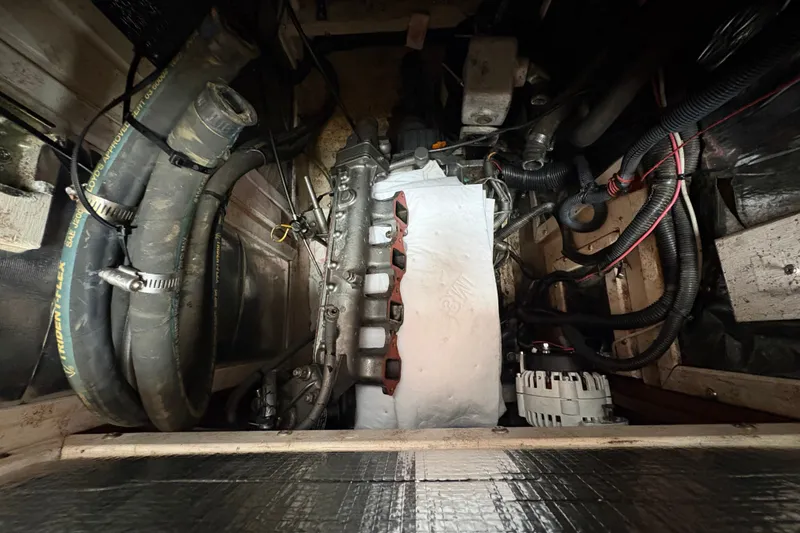 Slide: The Image of Engine compartment of a 2002 Caliber 40LRC with visible hoses and wiring. - 42