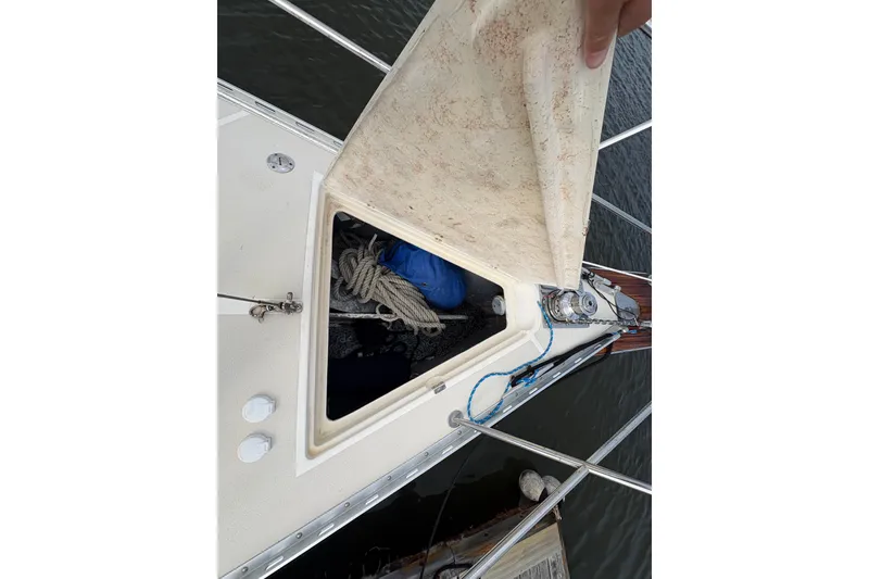 Slide: The Image of Open hatch on 2002 Caliber 40LRC sailboat, revealing ropes and equipment inside. - 11