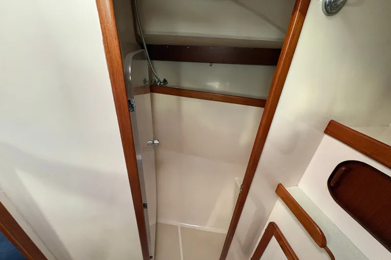 Slide: The Image of 2002 Caliber 40LRC yacht interior shower with wooden trim and compact design. - 23