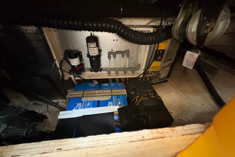 Slide: The Image of Engine compartment of a 2002 Caliber 40LRC with visible components and wiring. - 52
