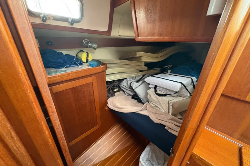 Slide: The Image of Cozy cabin interior of 2002 Caliber 40LRC sailboat with wooden furnishings and storage. - 39