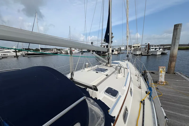 Slide: The Image of Sailboat docked at marina, Caliber 40LRC, 2002 model, clear sky, calm waters. - 9
