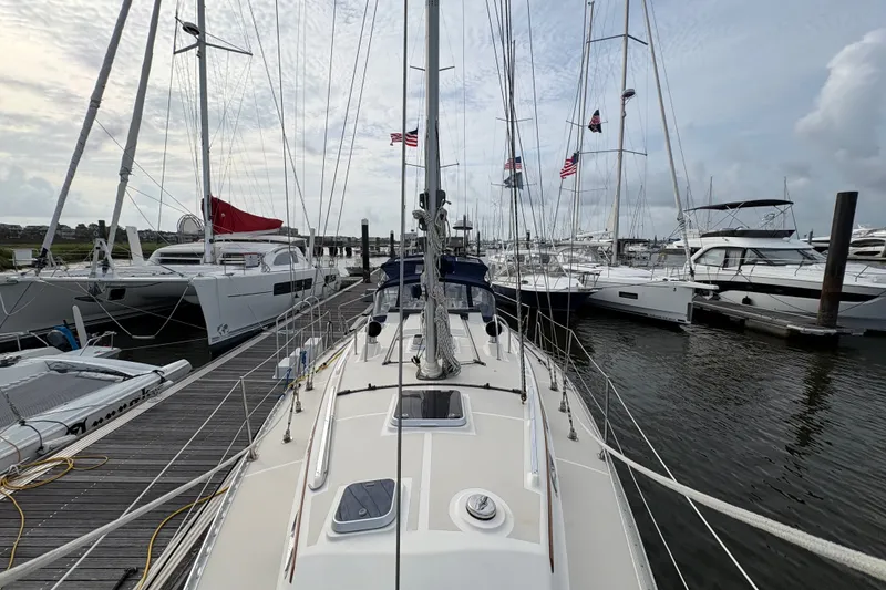 Slide: The Image of 2002 Caliber 40LRC sailboat docked among other yachts in a marina. - 7