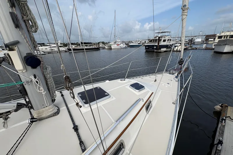 Slide: The Image of Sailboat docked in marina, 2002 Caliber 40LRC, surrounded by other boats under cloudy sky. - 8