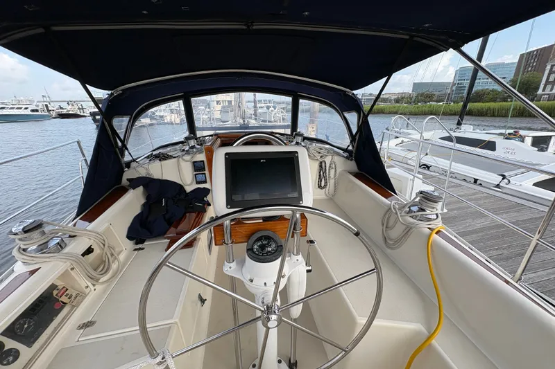 Slide: The Image of Cockpit of 2002 Caliber 40LRC sailboat with steering wheel and navigation equipment. - 14
