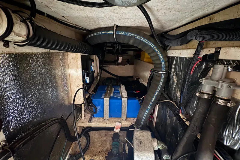 Slide: The Image of Engine compartment of a 2002 Caliber 40LRC sailboat with visible wiring and blue battery. - 41
