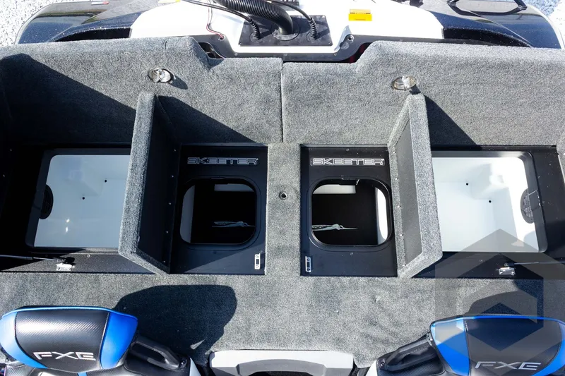 Slide: The Image of 2027 Skeeter FXE20 Pro boat storage compartments with open lids and FXE branding. - 21